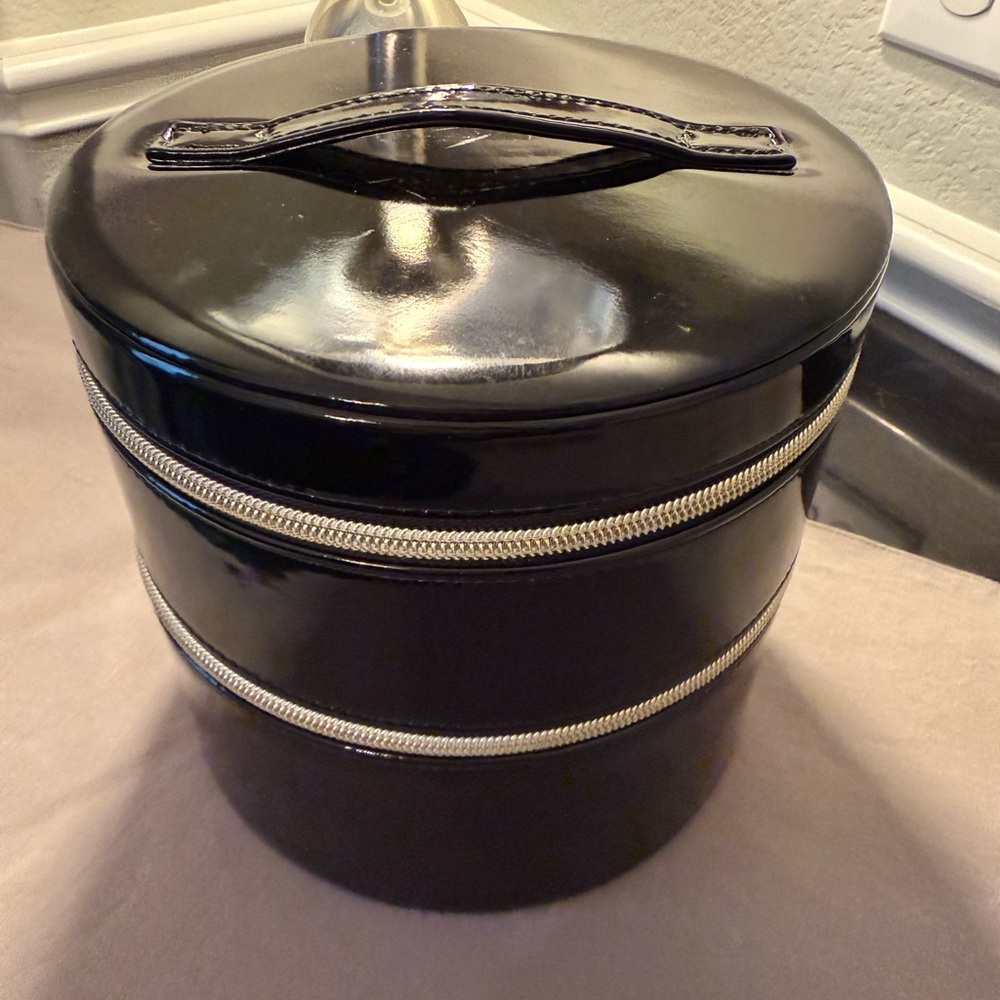 A glossy black Lancôme collector edition makeup organizer with mirror.